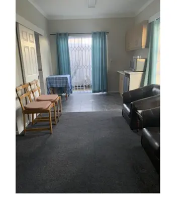 a living room with chairs and a couch and a table at Table Mountain Views in Cape Town