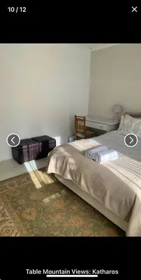 a bedroom with a bed and a desk at Table Mountain Views in Cape Town
