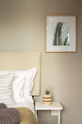 a bedroom with a bed and a mirror on the wall at Ocean Family Deluxe, Hermanus Waterfront Apartments in Hermanus