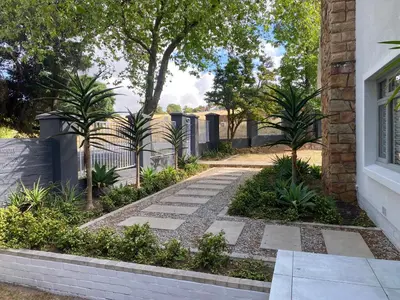 a garden with a stone walkway next to a house at 33 Tafelberg! in Cape Town