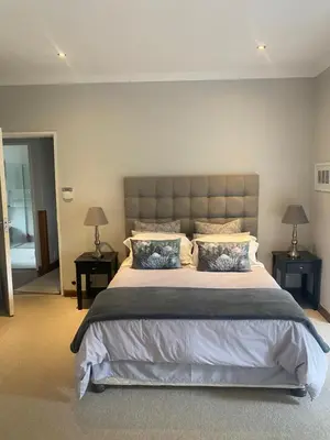 a bedroom with a large bed with two night stands at 33 Tafelberg! in Cape Town
