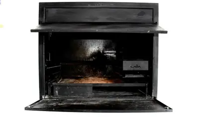 a black oven with the door open with a pizza inside at Sea and Mountain View Apartment in Cape Town