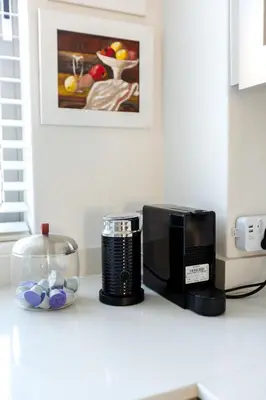 a kitchen counter with a microwave and a coffee maker at Waddle Inn Luxury apartment in Franschhoek in Franschhoek