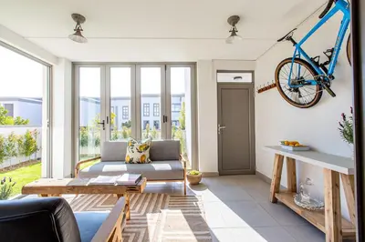 a living room with a bike hanging on the wall at Waddle Inn Luxury apartment in Franschhoek in Franschhoek