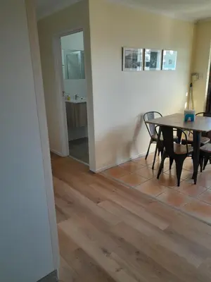 a dining room with a table and chairs at Luxury Studio sleeps up to 3 adults - Sunset Beach in Cape Town