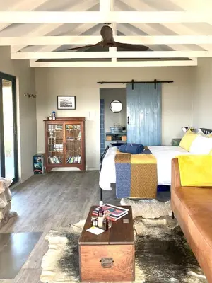 a living room with a bed and a couch at Skuilkrans Private Nature Reserve in McGregor