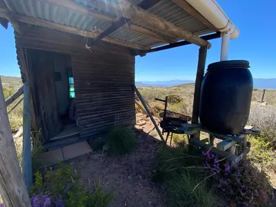 a small building with a large boiler in a field at Skuilkrans Private Nature Reserve in McGregor