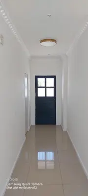 a hallway with a blue door and a tile floor at COMFORT LODGE milnerton, Cape Town in Cape Town