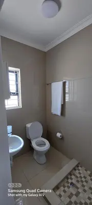 a bathroom with a toilet and a sink at COMFORT LODGE milnerton, Cape Town in Cape Town