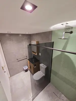 a bathroom with a toilet and a glass shower at Die Regte Rede in Cape Town