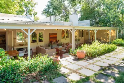 a house with a pavilion in a garden at Beautiful country house set in lush garden in Wellington