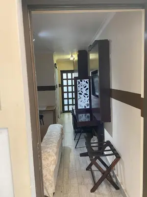 a living room with a tv and a chair in a room at Delash Pine Villa in Cape Town