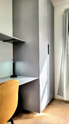 a desk in a room with a yellow chair at Aeon Nest in Parow