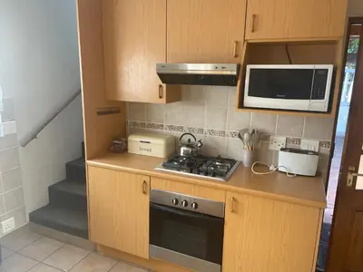 a small kitchen with a stove and a microwave at Morrison Hotel in Parklands