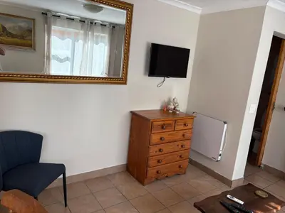 a room with a television and a dresser and a mirror at Morrison Hotel in Parklands