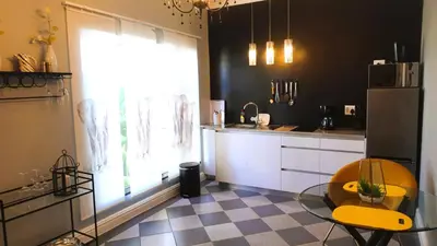 a kitchen with a glass table and a window at Big6 Guesthouse in Somerset West