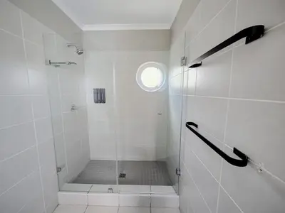 a bathroom with a shower with a glass door at Royal Boland in Paarl