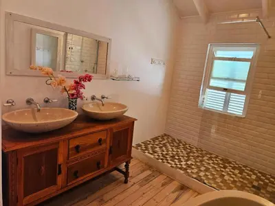 a bathroom with two sinks and a shower at PinotageLuxuryCollection 9A Herte Suite in Stellenbosch