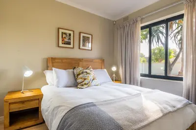 a bedroom with a bed and a large window at 59onLetchworth in Cape Town