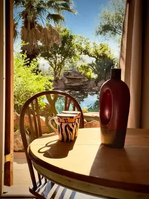 a table with a vase and a cup on a table at Tuscan Farmhouse near Franschhoek in Simondium