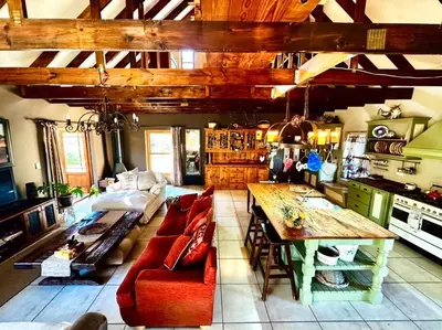 a living room with a couch and a table at Tuscan Farmhouse near Franschhoek in Simondium