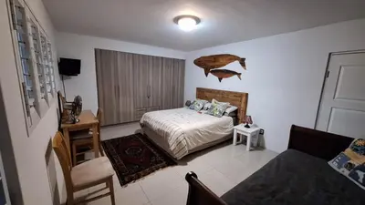 a bedroom with a bed and a chair in it at Budget Boutique in Blomtuin