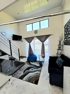 a living room with a couch and a window at Aqua Breeze in Cape Town