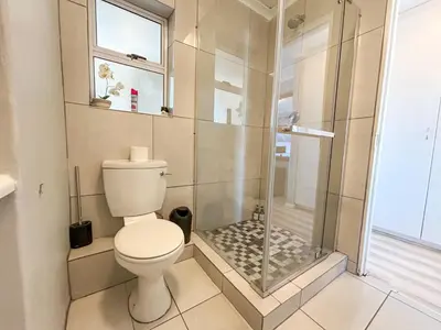 a bathroom with a toilet and a shower at Century Hideaway with Mountain views, Security, FREE Parking in Cape Town
