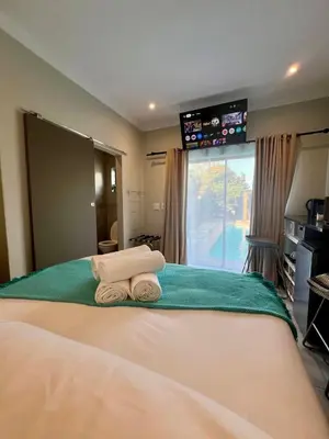 a bedroom with two towels sitting on a bed at Tehillah on Boom in Bothasig