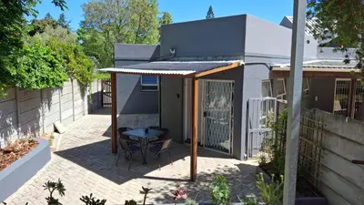 a patio with a table and a building at Dee-Ones at Witboom,Kenridge ,Self Catering Apartment in Kenridge