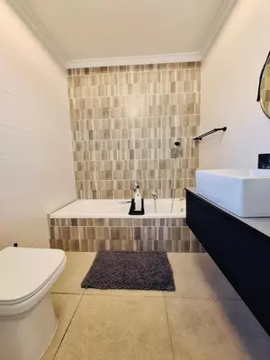 a bathroom with a toilet and a sink and a tub at Dee-Ones at Witboom,Kenridge ,Self Catering Apartment in Kenridge