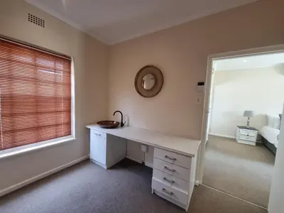 a white desk in a room with a window at The Nook in Stellenbosch