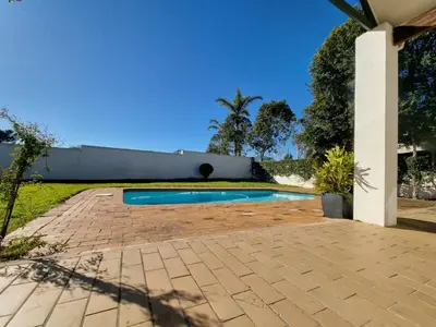a swimming pool in the backyard of a house at The Nook in Stellenbosch