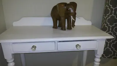 a statue of an elephant sitting on top of a dresser at Ocean Elephant Beach Apartment LONG TERM in Strand