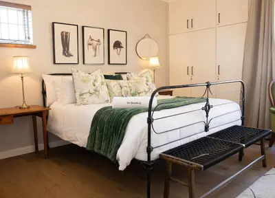 a bedroom with a bed with a green blanket at De Boerderij in Strand