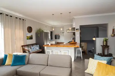 a living room with a couch and a kitchen at De Boerderij in Strand