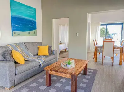 a living room with a couch and a coffee table at Chanteclair Re-Energised 1 Bed 1 Bath in Hermanus