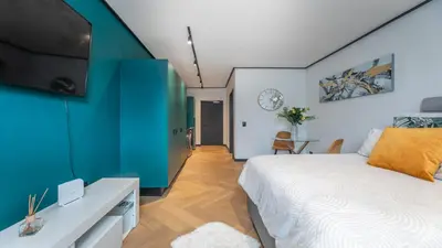 a bedroom with a bed and a green wall at Little island in Cape Town