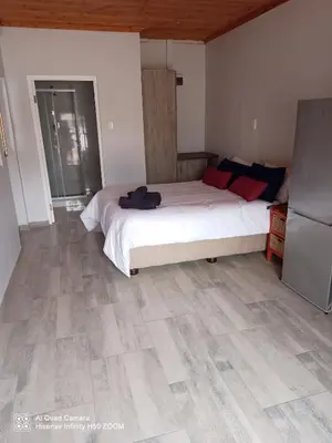 a bedroom with a large bed and a wooden ceiling at Jennings breeze in Cape Town