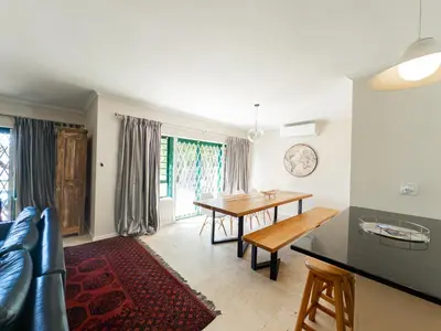 a kitchen and dining room with a table and chairs at Paradyskloof home in Stellenbosch