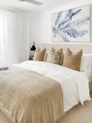 a white bedroom with a large bed with pillows at Duplicate in Franschhoek