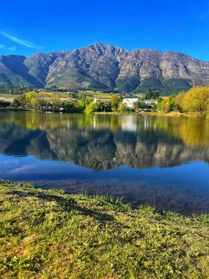 a view of a lake with mountains in the background at Duplicate in Franschhoek