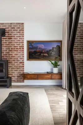 a living room with a painting on the wall at Lush garden 3 bedroom house in Franschhoek