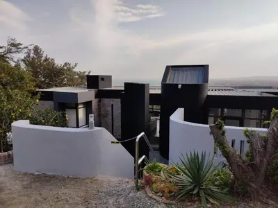 a modern house with a white fence at Gordon's Bay Sunset View in Cape Town