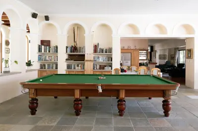 a pool table in the middle of a living room at Manor House at La Roche Estate - Franschhoek in Franschhoek