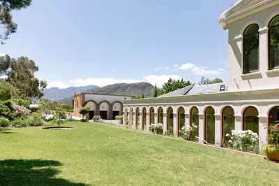an exterior view of a building with a yard at Manor House at La Roche Estate - Franschhoek in Franschhoek