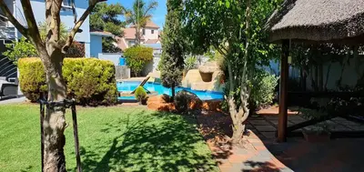 a house with a yard with a swimming pool at TUSCAN VILLA FELICE near West Coast in Cape Town