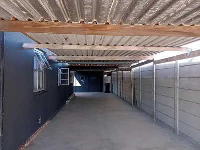 an empty hallway in a building with a wooden ceiling at Exotica Central guest house in Cape Town