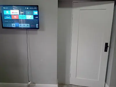 a flat screen tv hanging on a wall at Exotica Central guest house in Cape Town