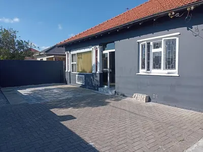 a house with a brick driveway in front of it at Exotica Central guest house in Cape Town